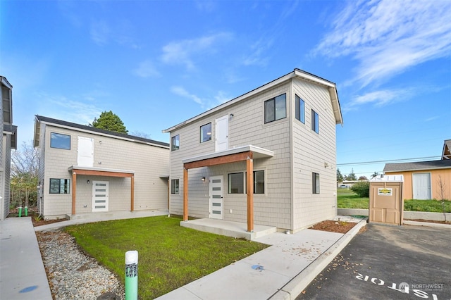 modern home with a garage and a front lawn