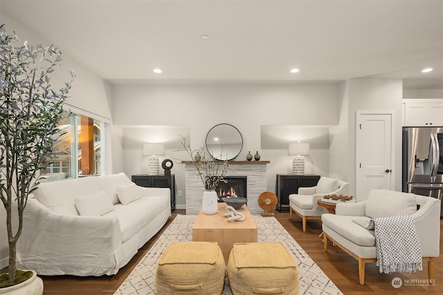 living room featuring hardwood / wood-style floors and a tile fireplace