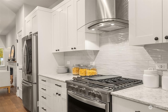 kitchen with white cabinetry, appliances with stainless steel finishes, and island exhaust hood