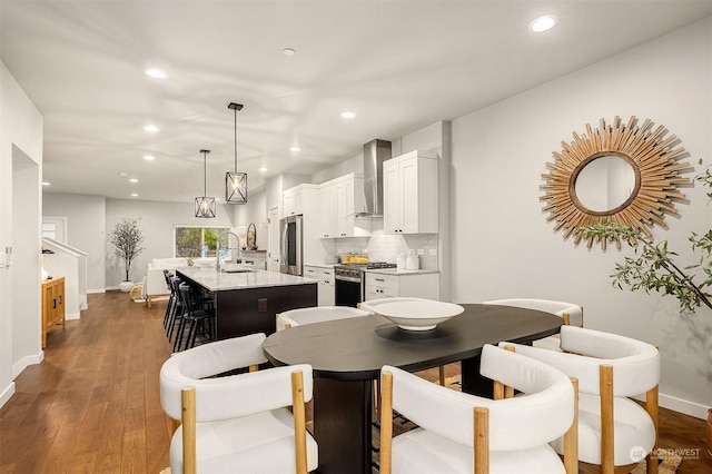 dining area featuring sink and dark wood-type flooring