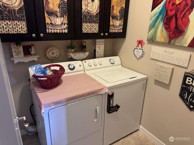 laundry area featuring separate washer and dryer, light tile patterned floors, and cabinets