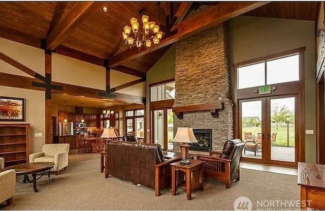 living room featuring french doors, beam ceiling, wood ceiling, a chandelier, and a fireplace