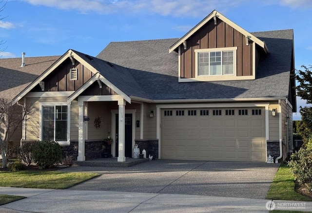 craftsman inspired home featuring board and batten siding, concrete driveway, a garage, and stone siding