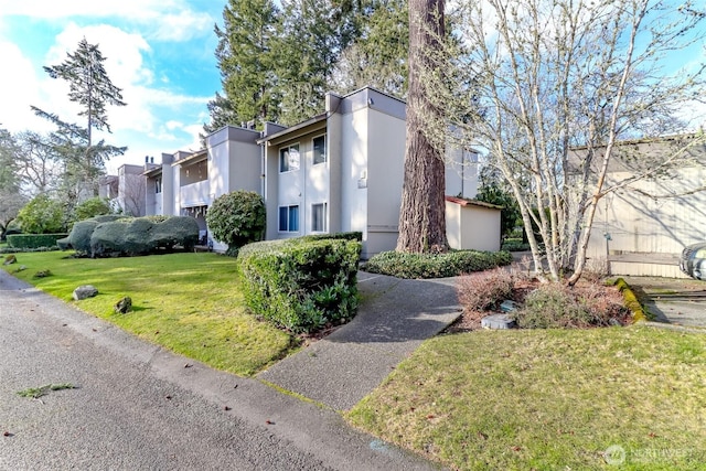 view of home's exterior featuring stucco siding and a yard