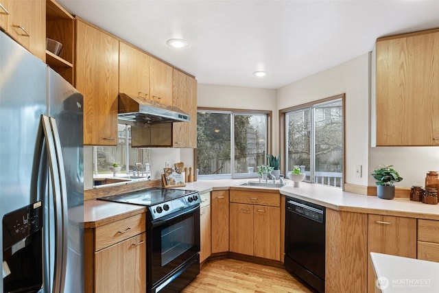 kitchen featuring under cabinet range hood, open shelves, a sink, light countertops, and black appliances