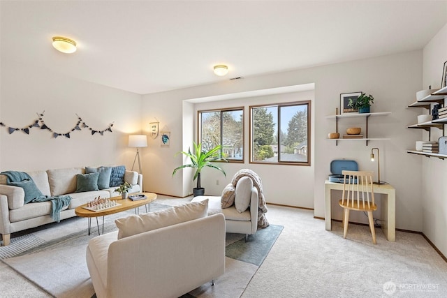 living room featuring light carpet and baseboards