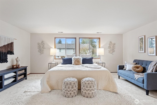 carpeted bedroom featuring visible vents