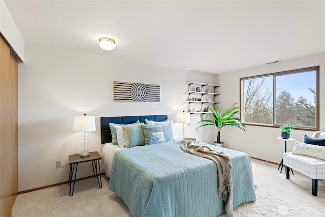 carpeted bedroom with visible vents and baseboards