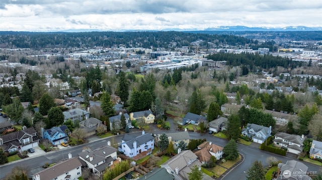 drone / aerial view featuring a residential view and a mountain view