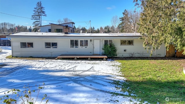 snow covered property featuring a lawn