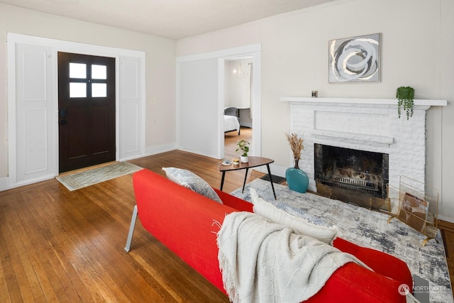 living room with dark wood-type flooring and a fireplace