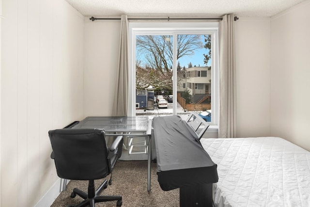 carpeted bedroom featuring a textured ceiling