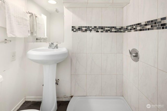 bathroom with tiled shower