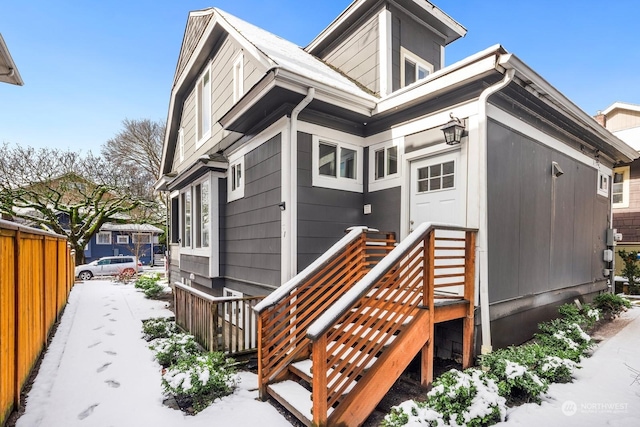 view of snow covered rear of property