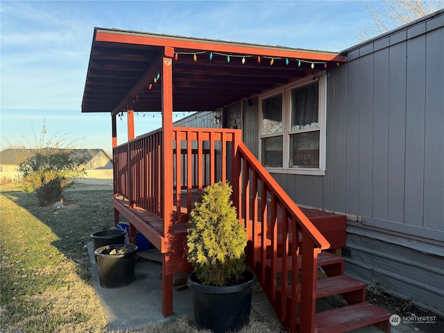 wooden deck featuring a lawn