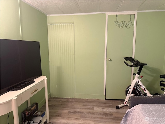 bedroom with a textured ceiling and light wood-type flooring