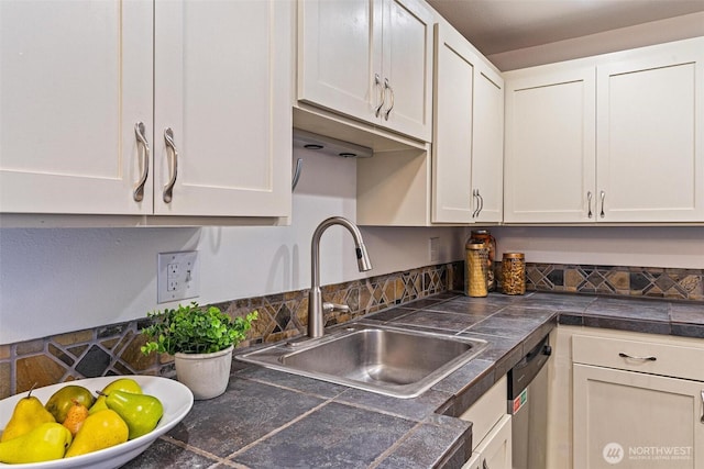 kitchen featuring a sink, dishwasher, white cabinets, and tile countertops