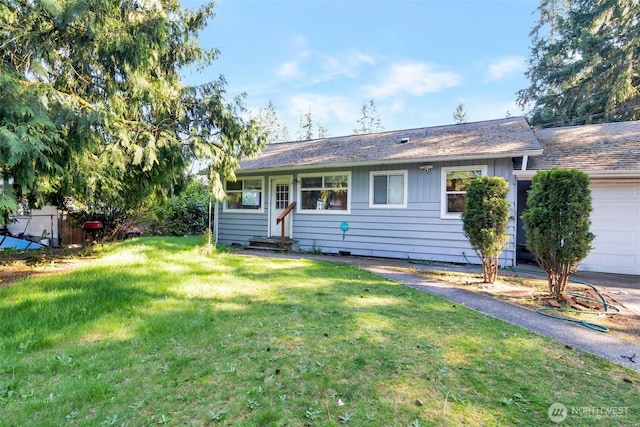 single story home with a front yard, a garage, entry steps, and fence