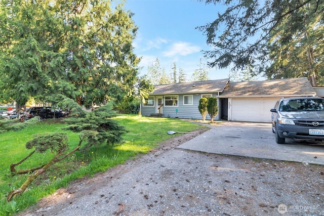 single story home featuring a garage, a front lawn, and driveway