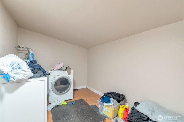 washroom featuring light wood-style floors, independent washer and dryer, laundry area, and baseboards
