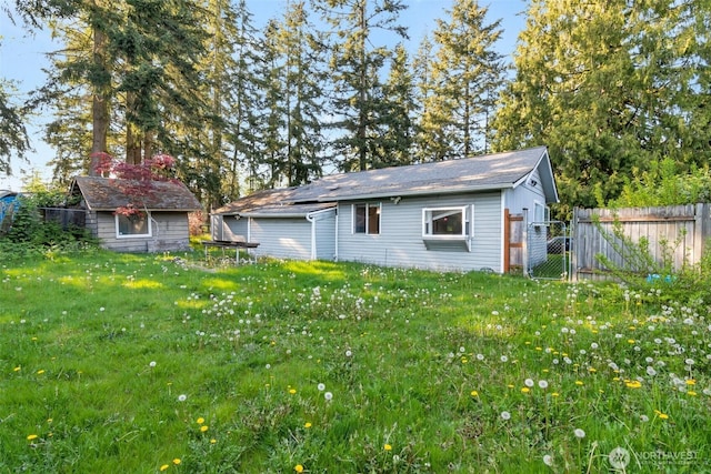 view of outbuilding featuring an outbuilding and fence