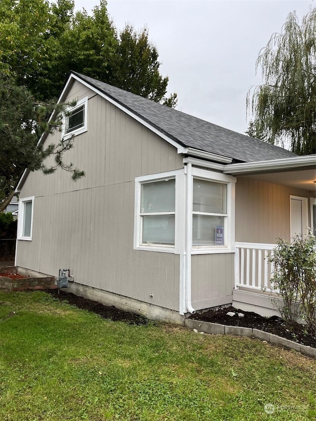 view of side of home with a lawn