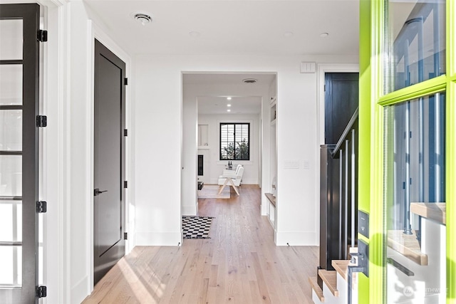 corridor with light hardwood / wood-style flooring