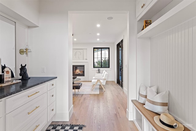 bathroom featuring vanity, hardwood / wood-style floors, and a tub