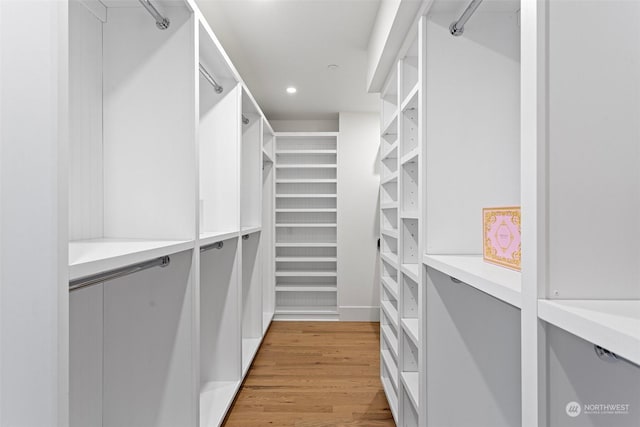 spacious closet with light hardwood / wood-style floors