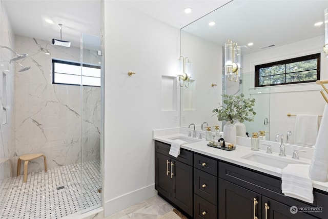 bathroom with vanity and a shower with door