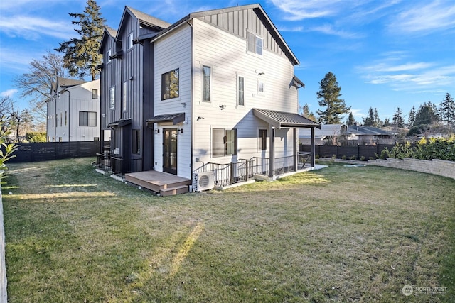 rear view of house with a lawn