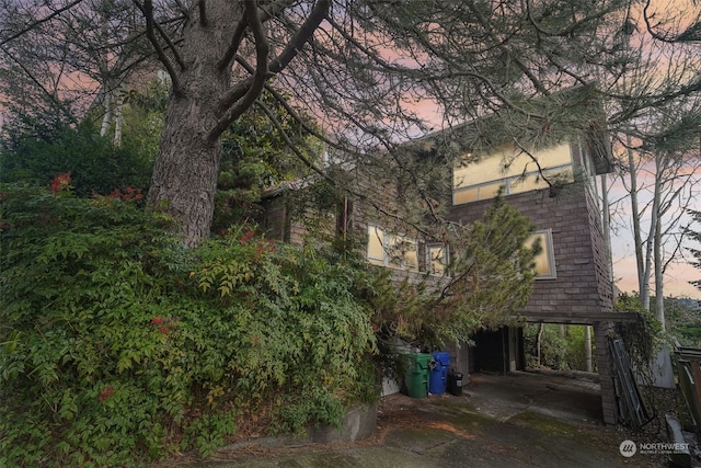 property exterior at dusk with a carport