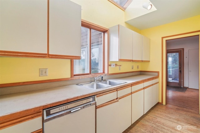 kitchen featuring white cabinetry, light hardwood / wood-style floors, dishwashing machine, and sink