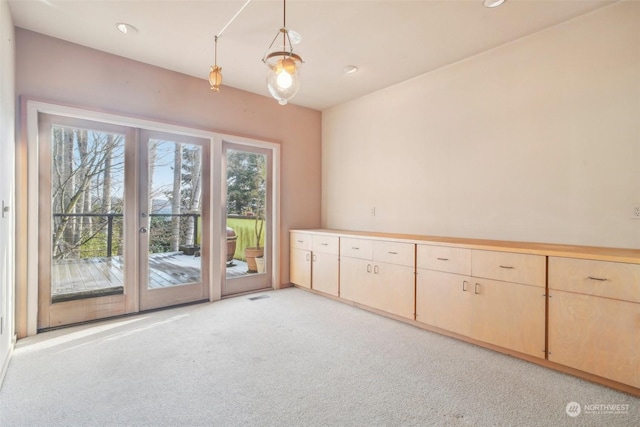 carpeted spare room with french doors