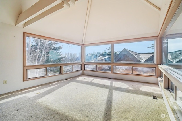 unfurnished sunroom featuring vaulted ceiling with beams