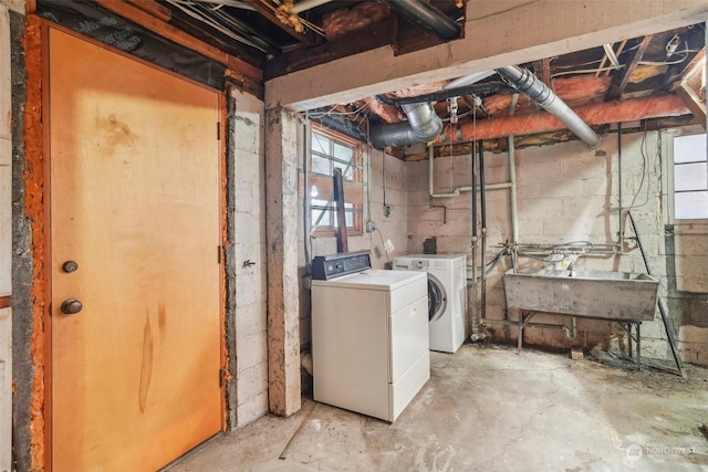 basement featuring sink and washer and dryer