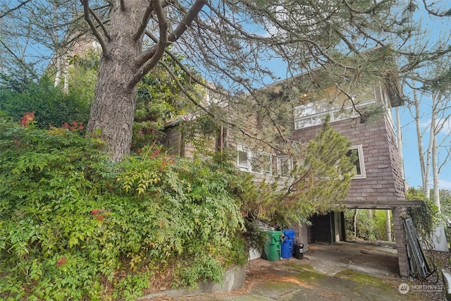 rear view of property featuring a carport