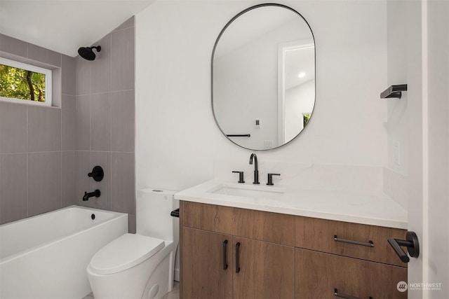 full bathroom featuring tiled shower / bath combo, vanity, and toilet