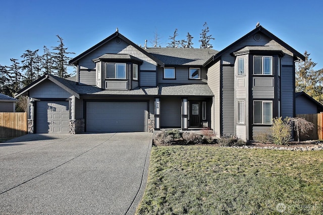 view of front of property with a front yard and a garage