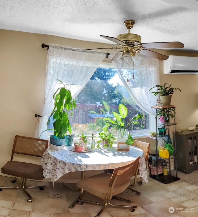 dining area with ceiling fan, a wall mounted air conditioner, and a textured ceiling