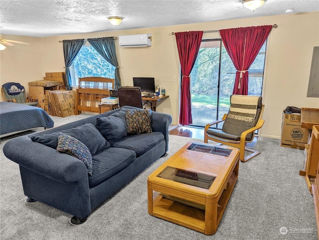 carpeted living room featuring ceiling fan, an AC wall unit, and a textured ceiling