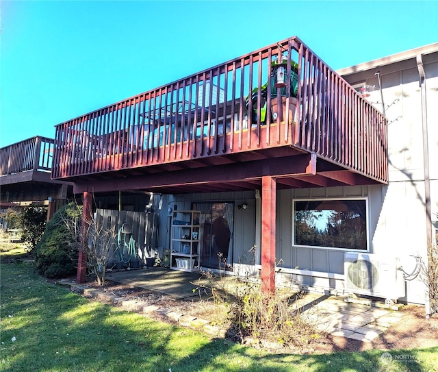 rear view of property featuring a yard and ac unit