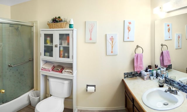 bathroom with a shower with door, vanity, and toilet