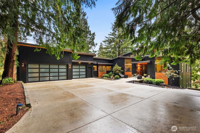 contemporary home with driveway and an attached garage