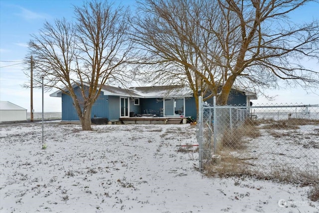 view of snow covered rear of property