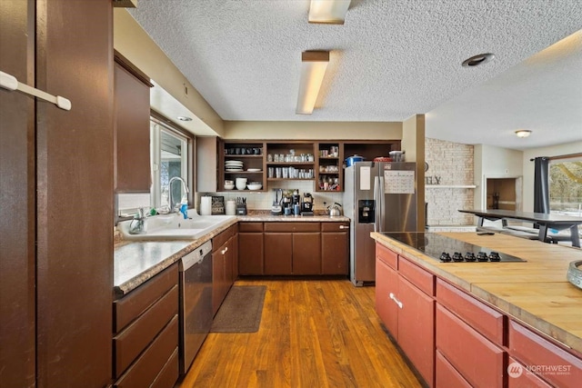 kitchen with sink, wooden counters, appliances with stainless steel finishes, dark hardwood / wood-style floors, and decorative backsplash