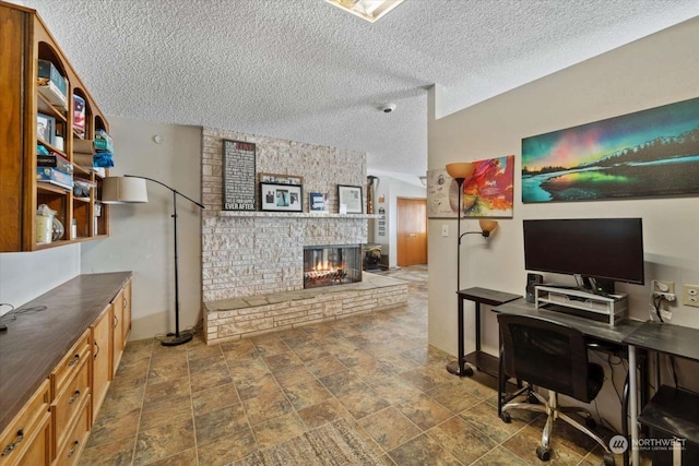 office space featuring a brick fireplace and a textured ceiling