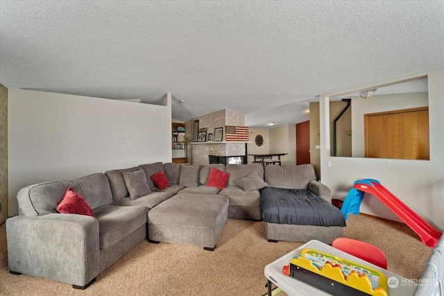 carpeted living room featuring a textured ceiling and a fireplace