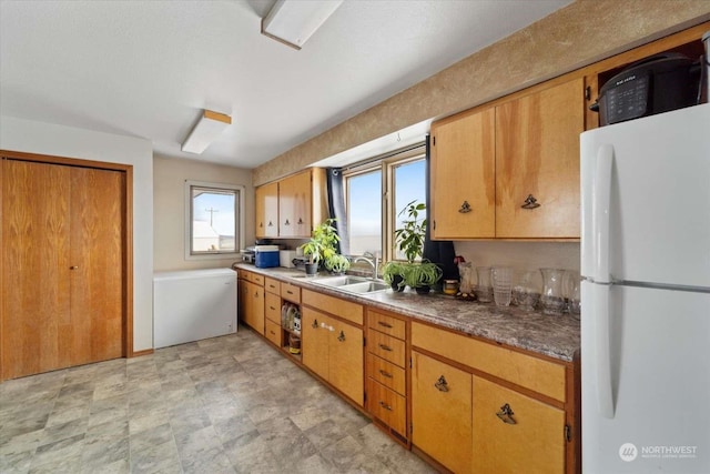 kitchen with sink and white fridge