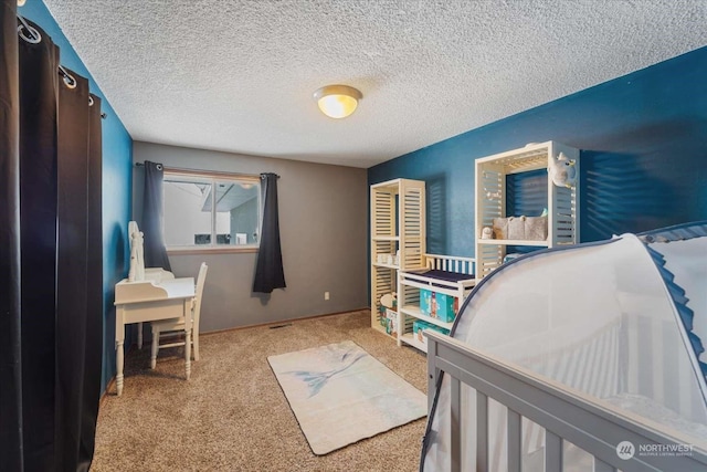 bedroom featuring carpet flooring and a textured ceiling